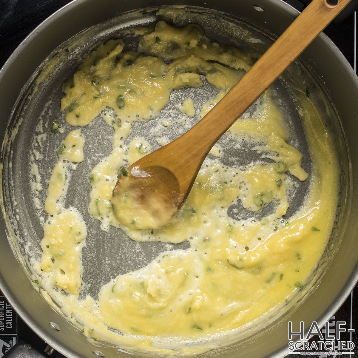 A pot with a wooden spoon, sage and flour