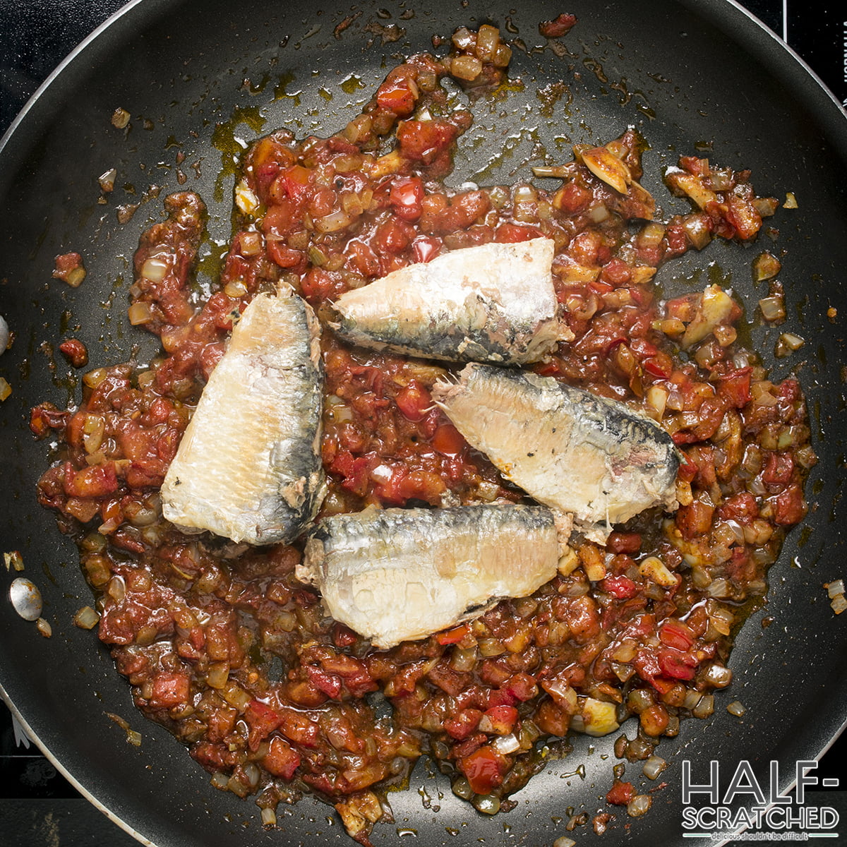  Adding the sardines to the tomato sauce