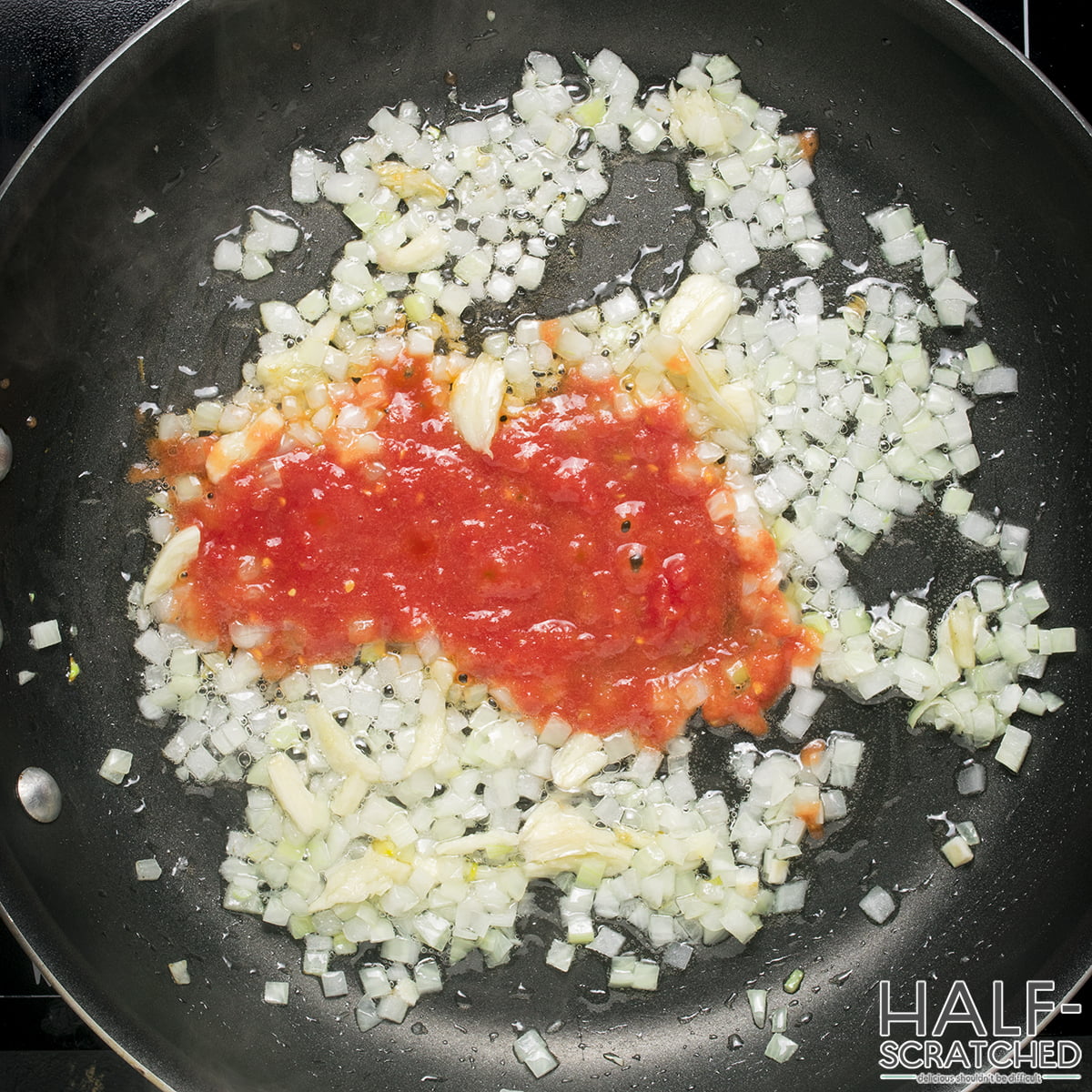 Frying onion, garlic and tomato sauce