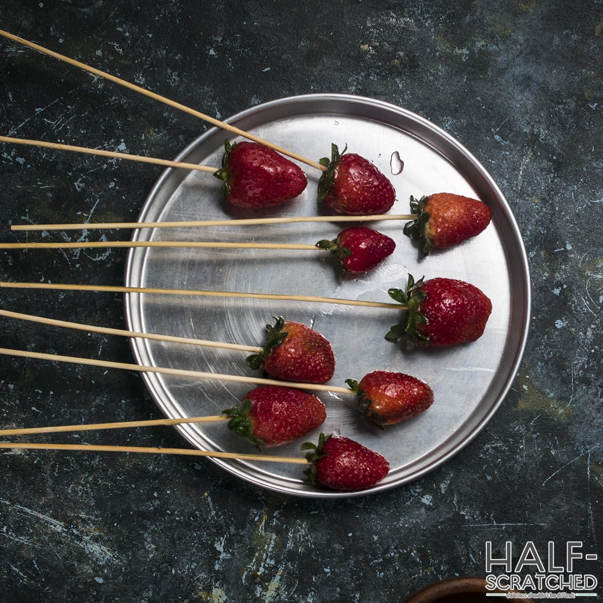 An overhead view of a tray with candied strawberries