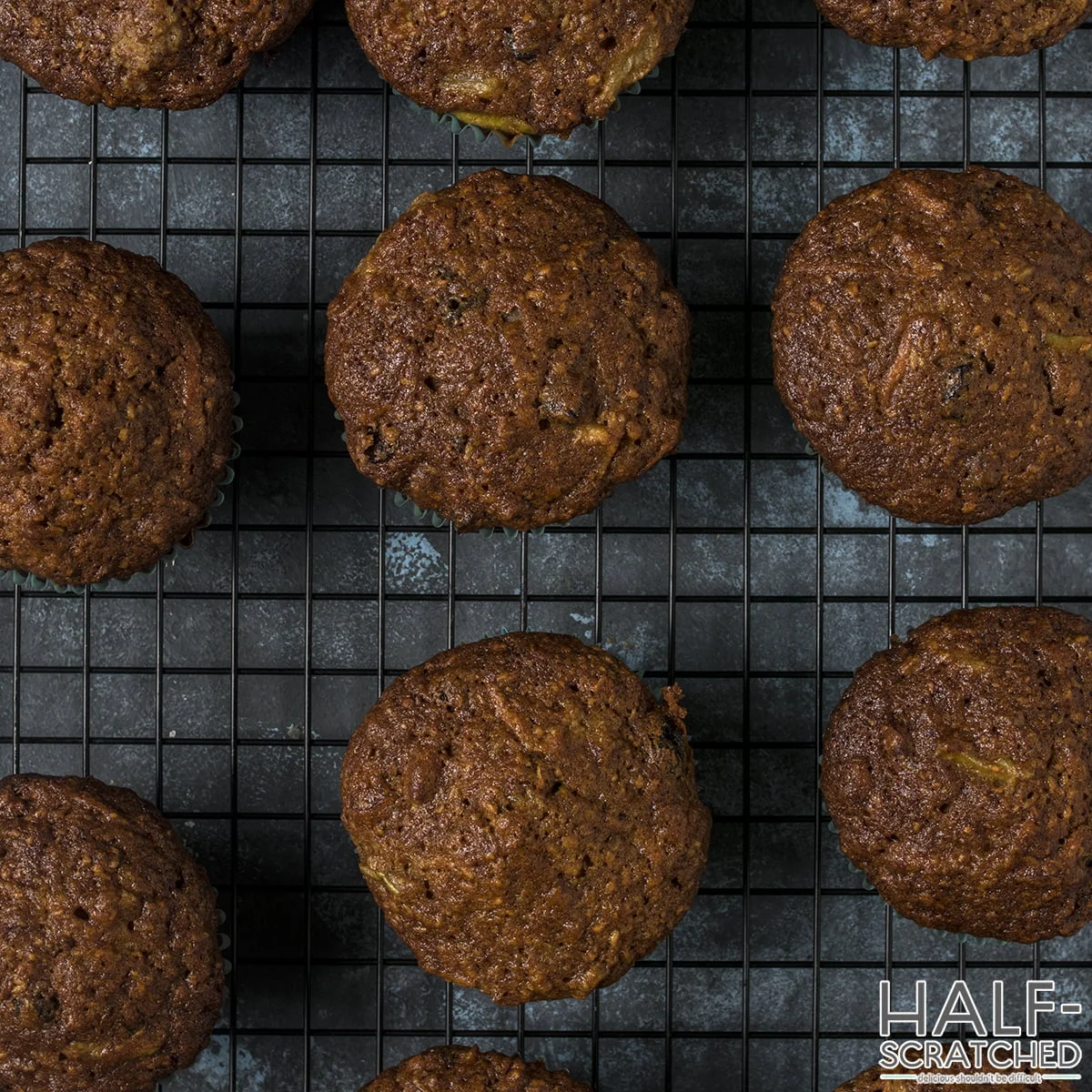 Freshly baked morning glory muffins on a cooling rack