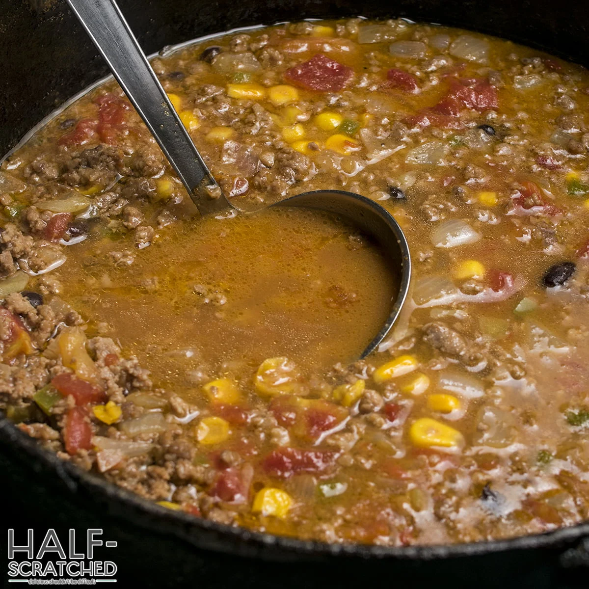 Ladling Pioneer Woman's taco soup from the pot