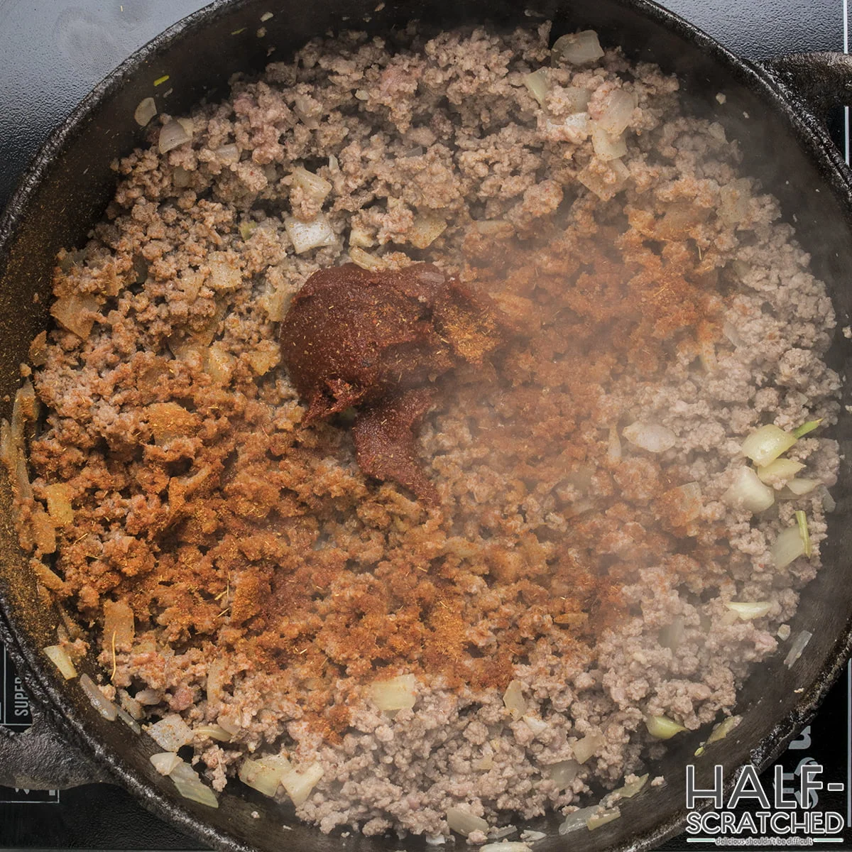 Adding tomatoes to the taco soup mixture
