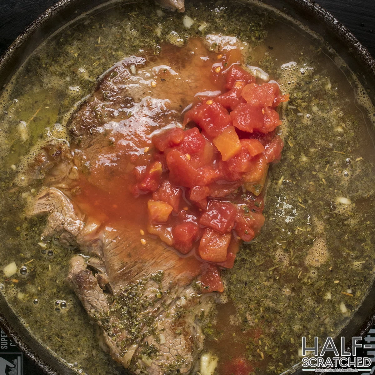 Adding tomatoes to the beef and barley soup